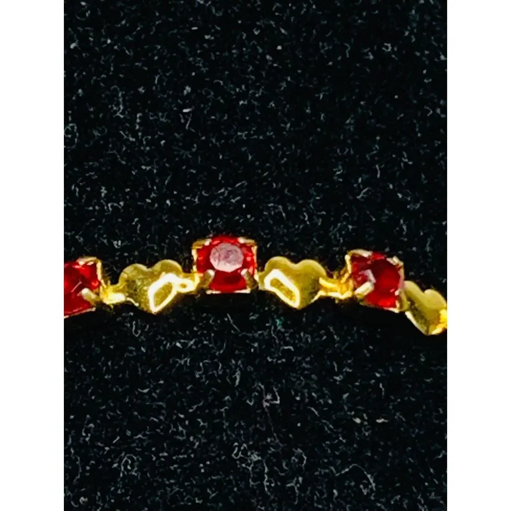 Red Stone Tennis Bracelet with Little Gold Hearts in Between Each Stone